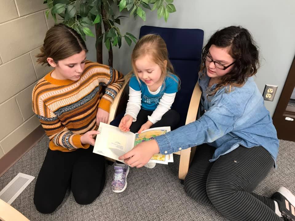 3 students reading together