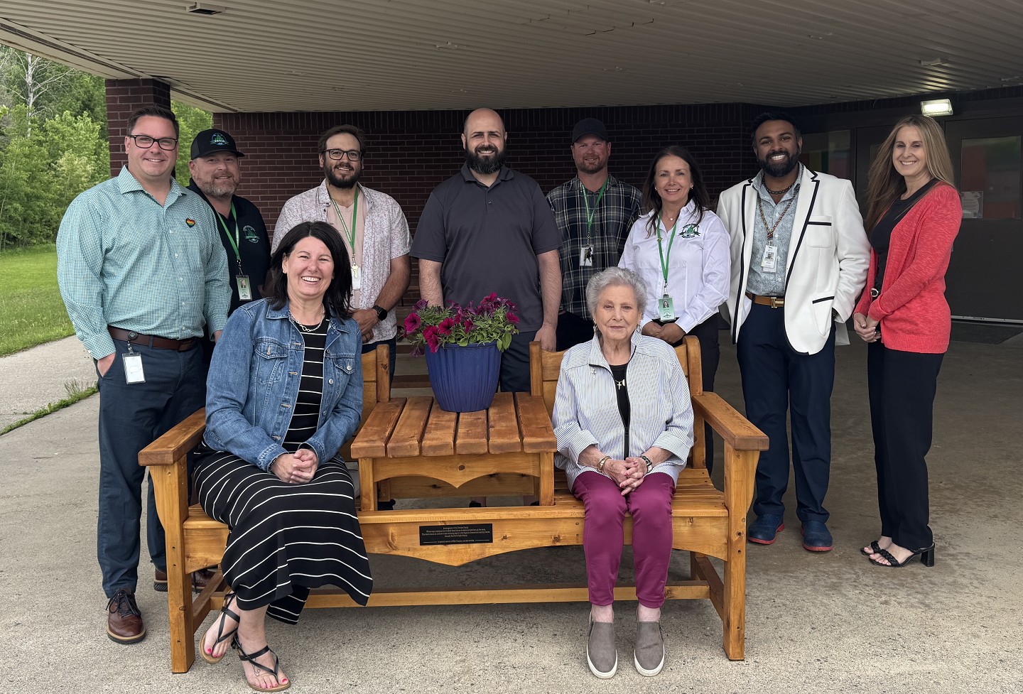 Staff and family pictured with tribute bench donation