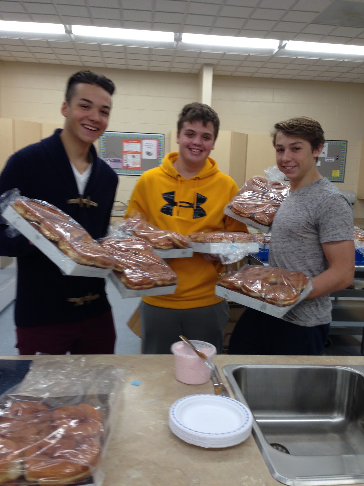 students we day holding persian donuts