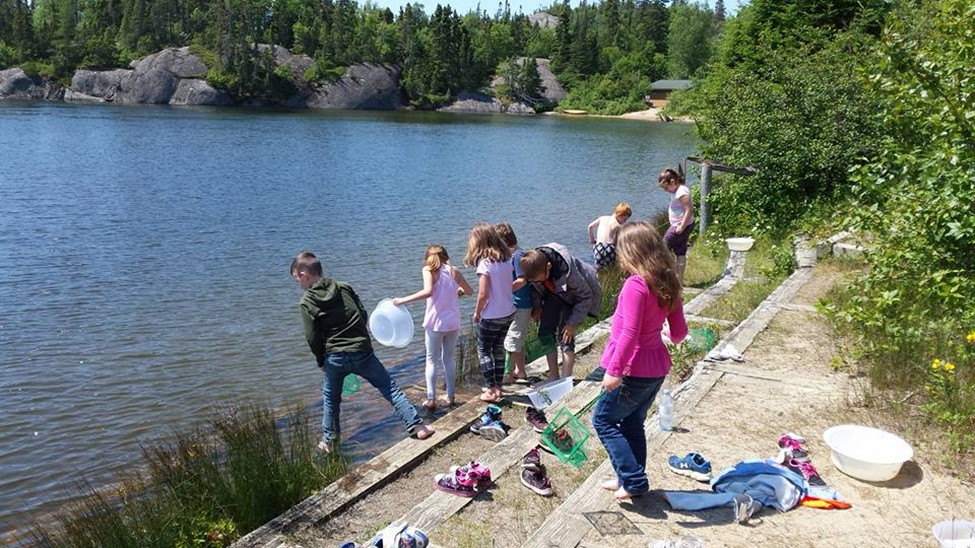 summer literacy students playing by lakeside